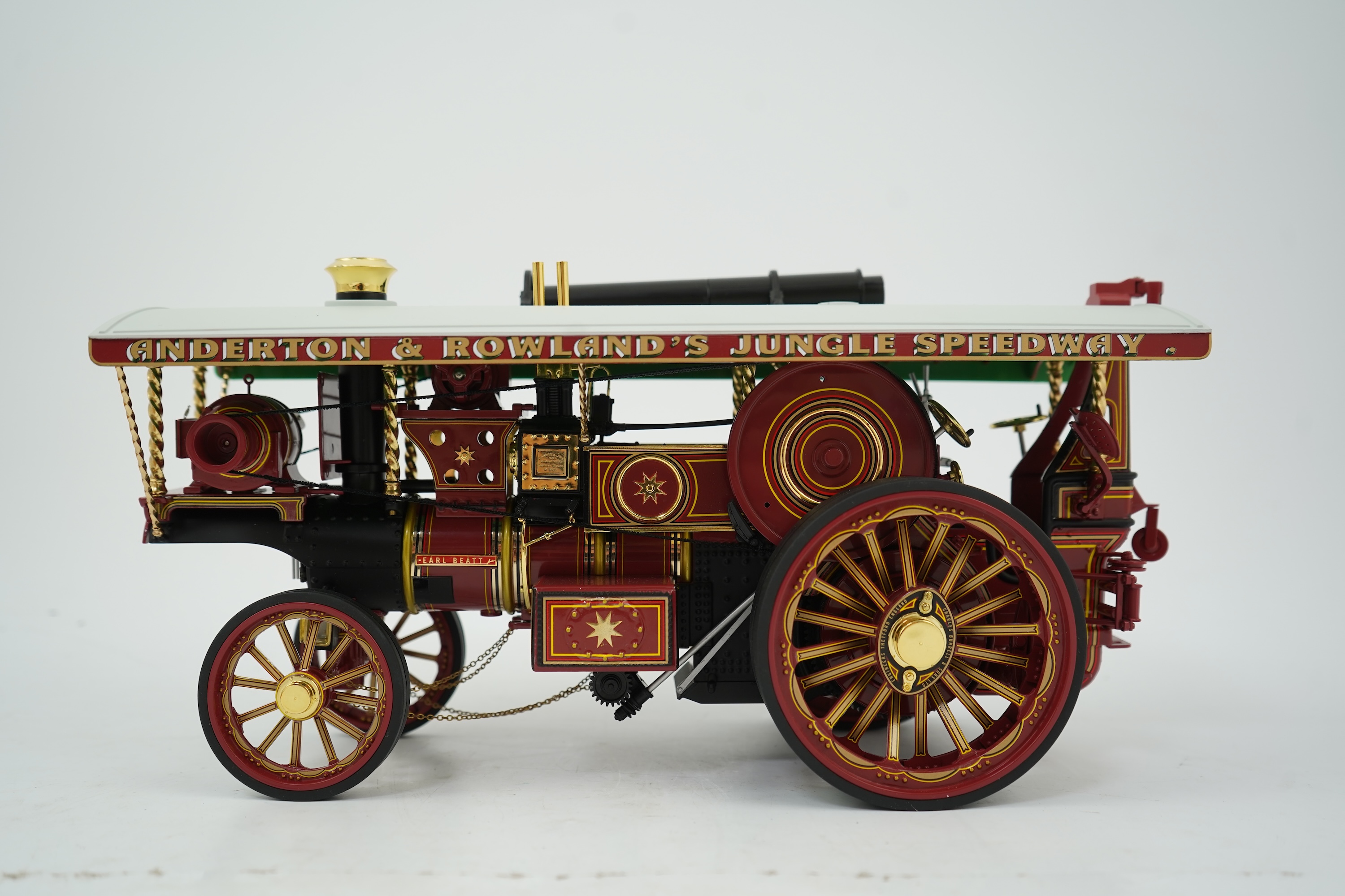 A Midsummer Models Ltd. 1:24 scale model of a Burrell Showman’s Engine, Earl Beatty, in ‘Anderson & Rowland’s Jungle Speedway’ livery, missing the original card box, but with an oak and Perspex display case